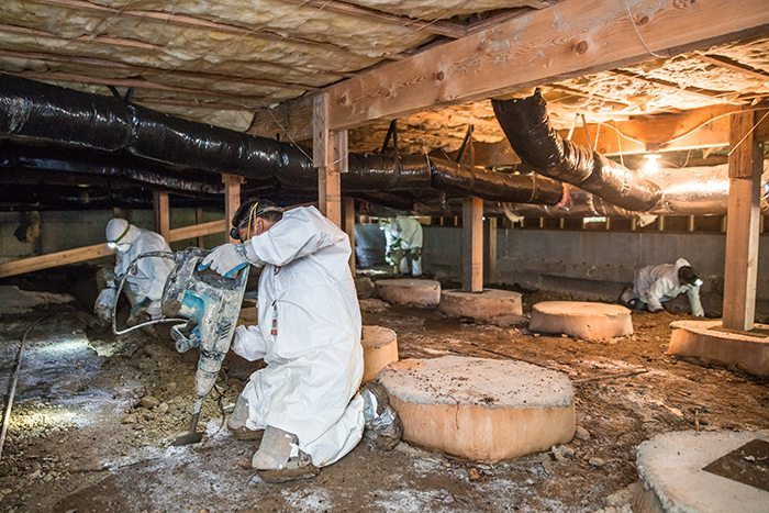 Crawl Pros professionals performing a water damage service in a crawl space