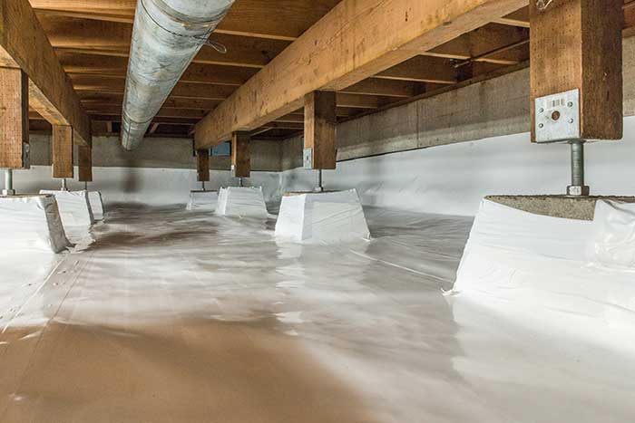 Crawl space outfitted with encapsulation material to protect the space