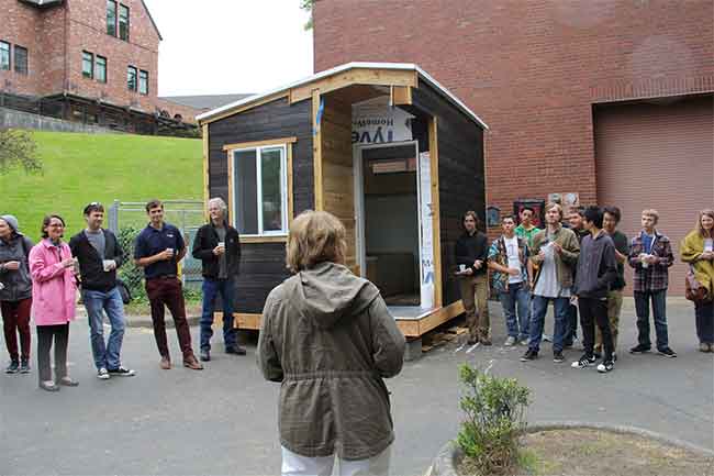 Crawl Pros professionals and students gathered around a tiny home to celebrate the Tiny House project at Annie Wright school