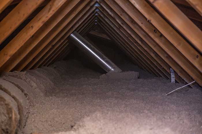 New attic insulation material installed by Crawl Pros professional to save on cooling costs