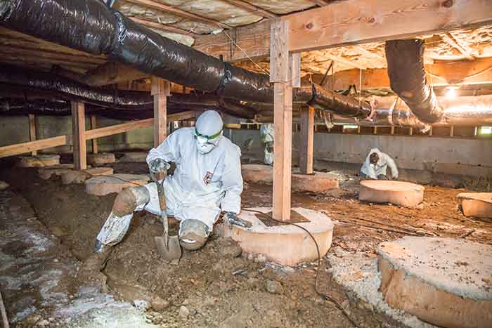 Crawl Pros professional prepping a crawl space for water remediation