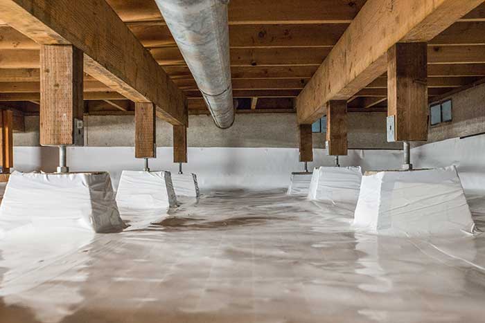 Crawl Pros professionally installed vapor barrier in a crawl space