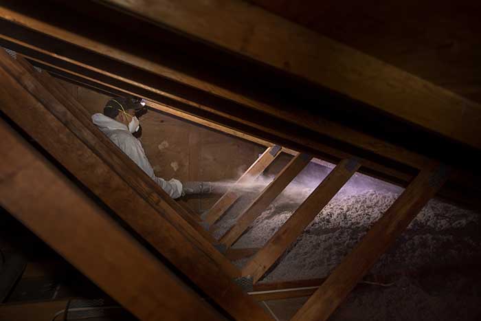 Crawl Pros professional installing new attic insulation material