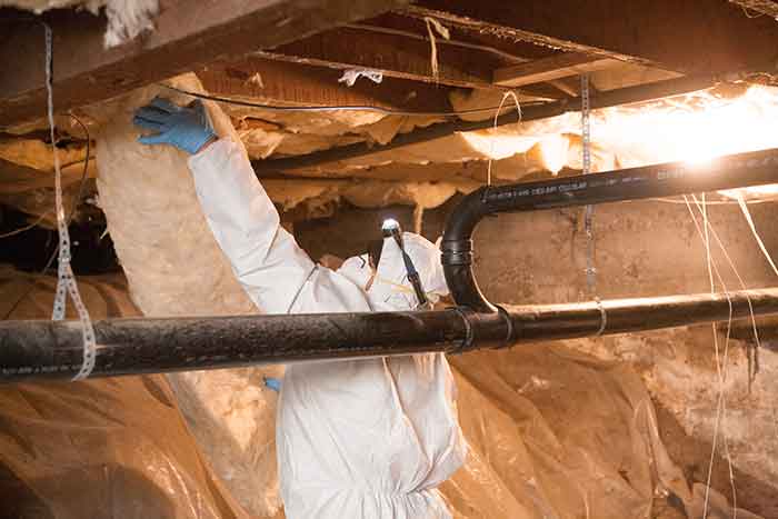 Crawl Pros professional installing new crawl space insulation material