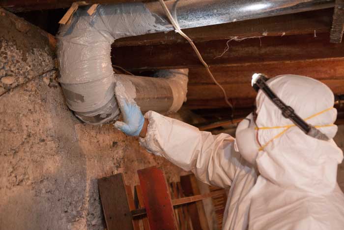 Crawl Pros professional sealing air ducts in a crawl space