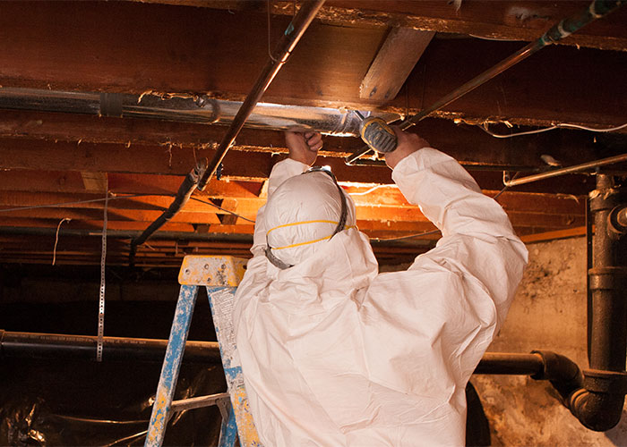 Crawl Pros professional installing new duct sealants in a crawl space