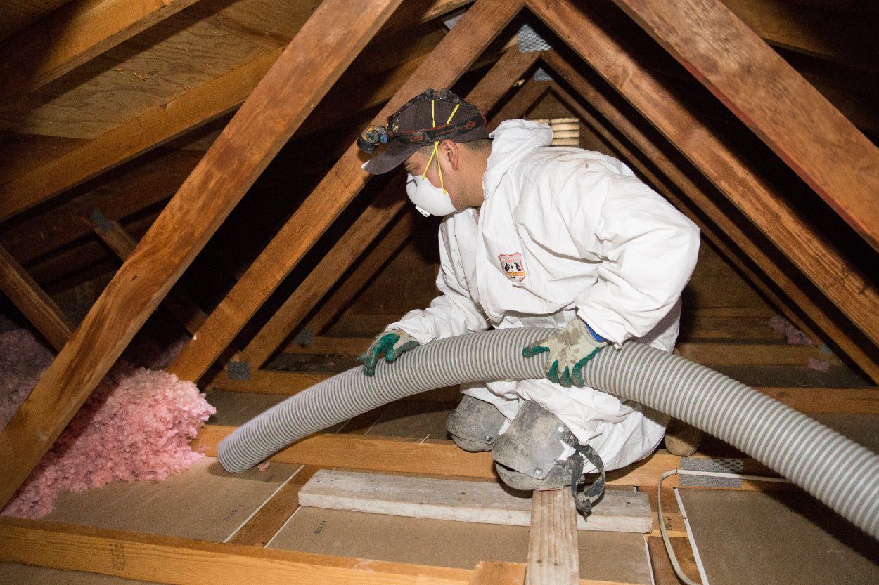 Crawl Pros professional installing new insulation in an attic