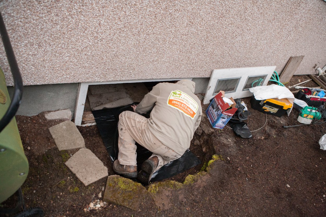 Crawl Pros professional preparing to enter crawl space
