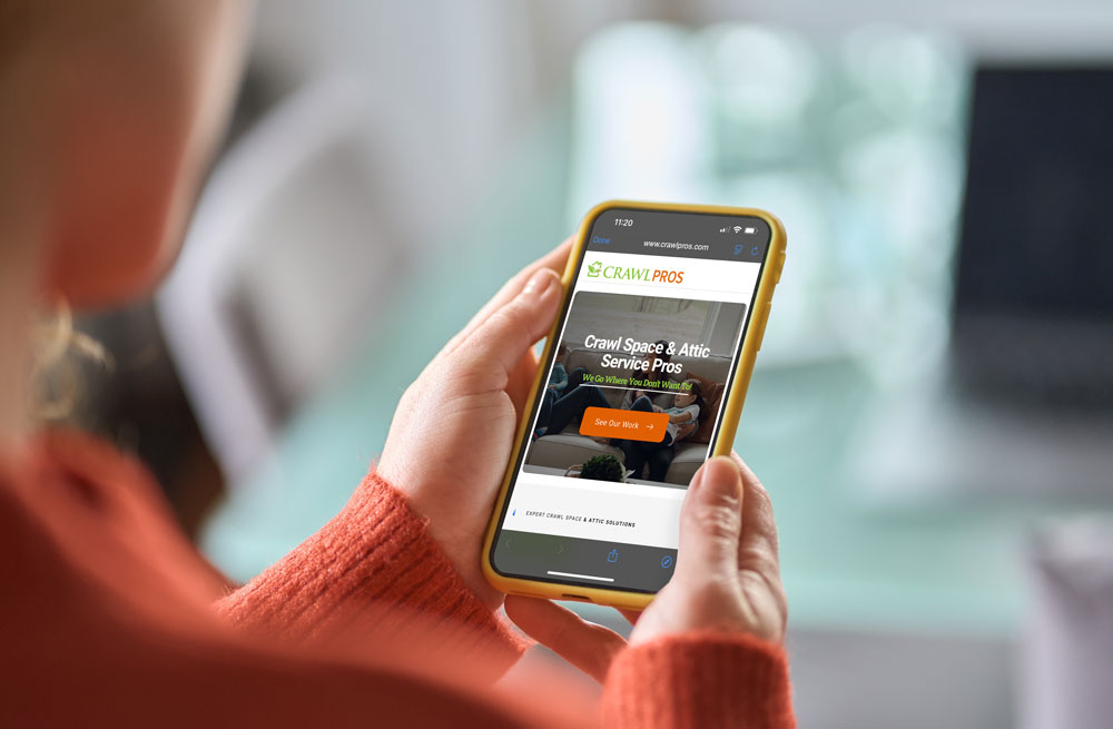 Someone looking up Crawl Pros website on a mobile phone