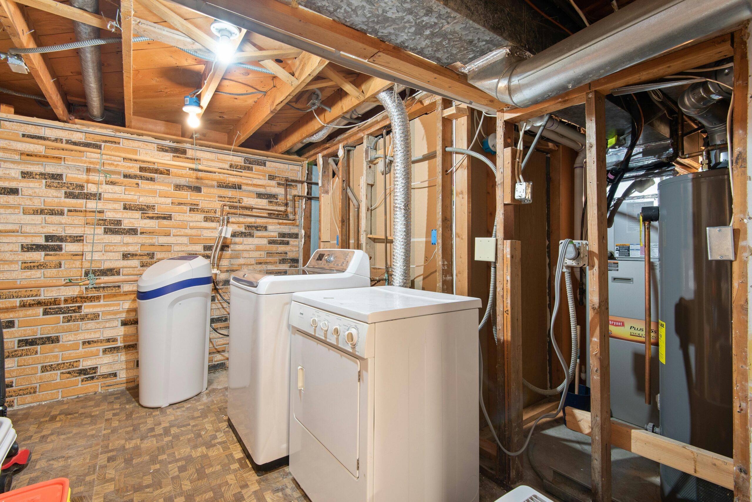 Air ducts connecting to a washer and dryer in a crawl space before an air duct cleaning and insulation