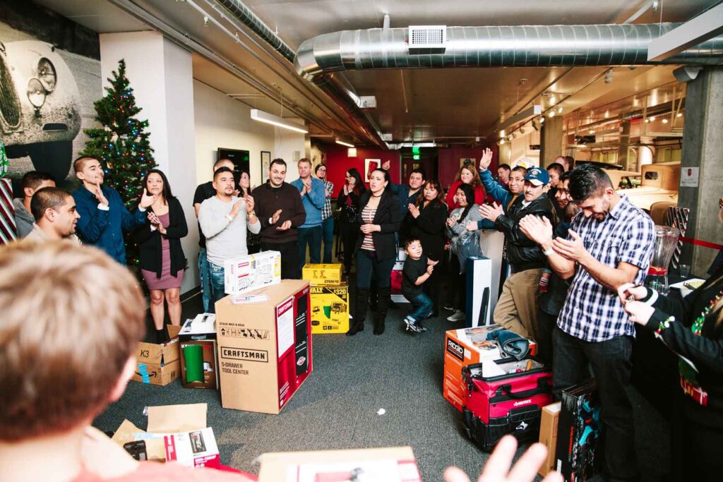 Crawl Pros team circled around each other and celebrating at a company Christmas party