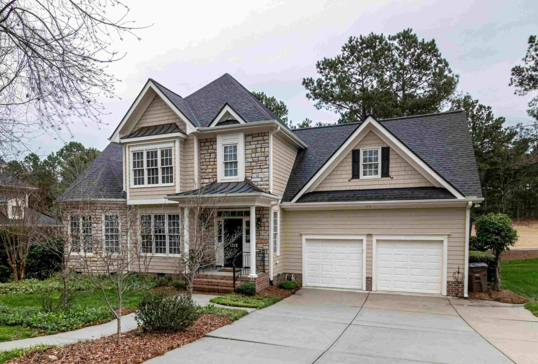 Single-family home with a tan front and white accents